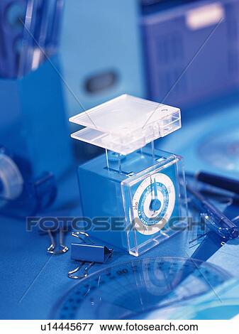 Stock Photo - Weighing scale and stationeries in blue. Fotosearch
