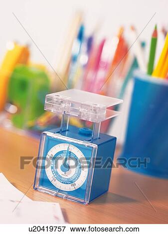 Weighing scale and stationeries on table View Large Photo Image Stock Photo - Weighing scale and stationeries on table. Fotosearch