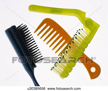 Stock Photograph - Hair brushes and comb, high angle view, white background. Fotosearch