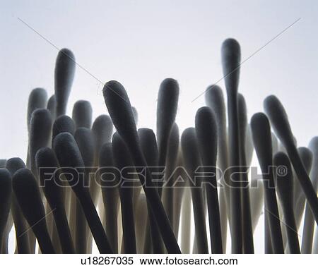 Stock Photography - Mass of cotton swabs, front view, close up, colored background. Fotosearch