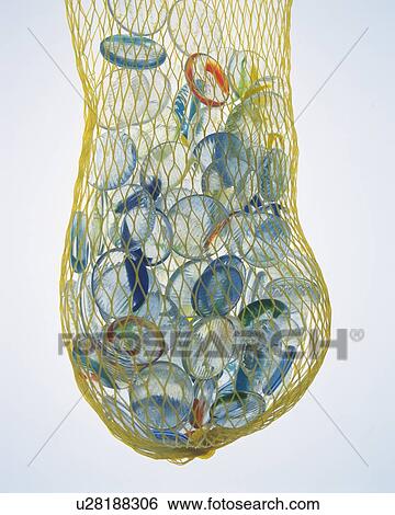 Stock Photograph - Mass of marbles in net, front view, colored background. Fotosearch