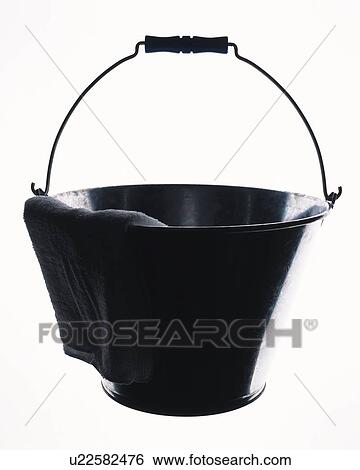 Stock Photograph - Rag hung on bucket, front view, white background. Fotosearch