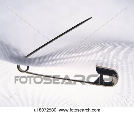 Safety pin in white clothing, close up View Large Photo Image Stock Image - Safety pin in white clothing, close up. Fotosearch