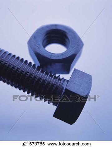 Stock Photography - Screw and nut, high angle view, close up, colored background, toned image. Fotosearch