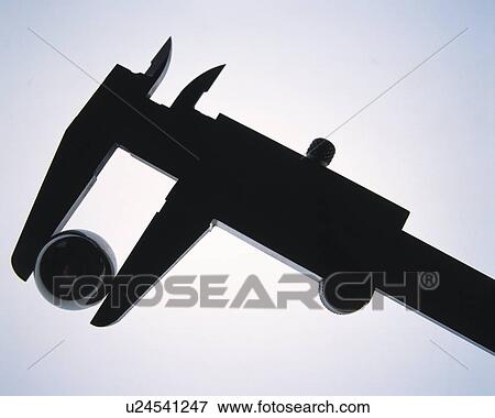 Stock Photo - Silhouette of ball in micrometer, side view, white background. Fotosearch