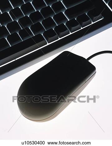 Stock Image - Silhouette of computer keyboard and mouse, high angle view, close up, white background. Fotosearch