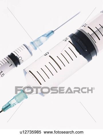 Stock Photography - Two syringes, high angle view, close up, white background. Fotosearch