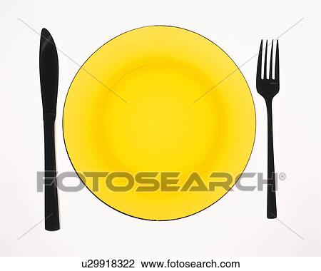 Yellow plate and silhouette of fork and knife, high angle view, white background View Large Photo Image Stock Image - Yellow plate and silhouette of fork and knife, high angle view, white background. Fotosearch