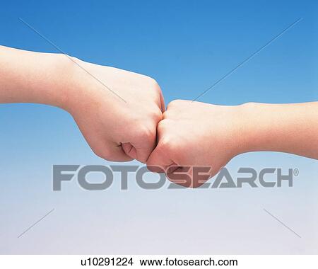 Fists of two women touching View Large Photo Image Picture - Fists of two women touching. Fotosearch