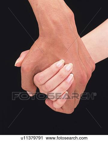 Woman and man holding hand of each other View Large Photo Image Stock Image - Woman and man holding hand of each other. Fotosearch