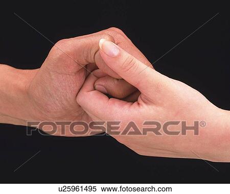 Stock Photography - Woman and man thumb wrestling . Fotosearch