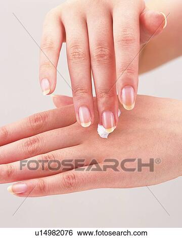 Woman applying cream on hand View Large Photo Image Stock Photograph - Woman applying cream on hand. Fotosearch