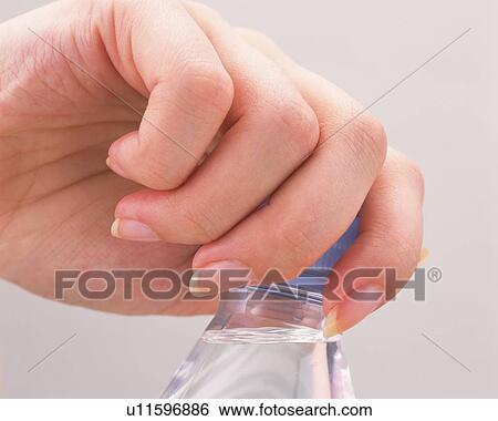 Woman clasping cap of a plastic bottle View Large Photo Image Stock Photograph - Woman clasping cap of a plastic bottle. Fotosearch