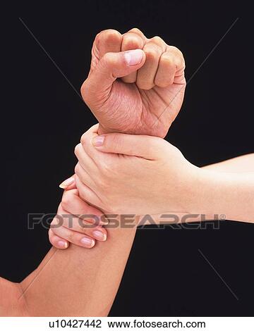 Woman gripping arm of man with fist View Large Photo Image Stock Image - Woman gripping arm of man with fist. Fotosearch