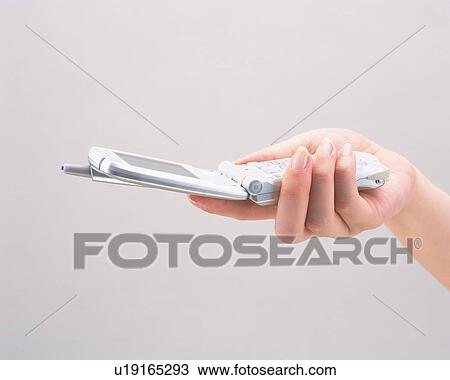 Woman holding a mobile phone View Large Photo Image Stock Image - Woman holding a mobile phone. Fotosearch