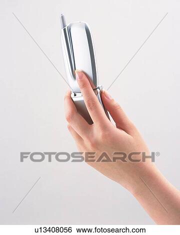 Woman holding a mobile phone View Large Photo Image Stock Photograph - Woman holding a mobile phone. Fotosearch