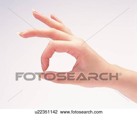 Woman making a circle with thumb and forefinger View Large Photo Image Stock Image - Woman making a circle with thumb and forefinger. Fotosearch
