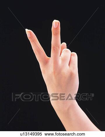 Woman making peace sign View Large Photo Image Stock Photography - Woman making peace sign. Fotosearch