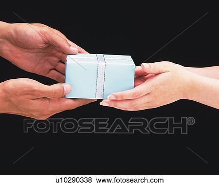 Stock Photo - Woman passing present to man. Fotosearch