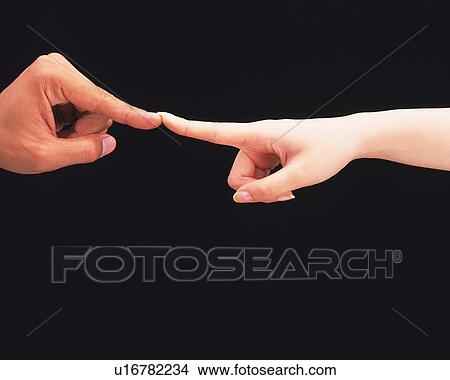 Picture - Woman pushing finger tip of man. Fotosearch