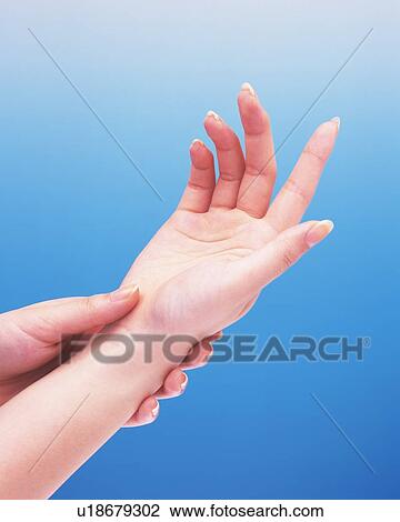 Woman putting her wrist on the other hand View Large Photo Image Stock Image - Woman putting her wrist on the other hand. Fotosearch