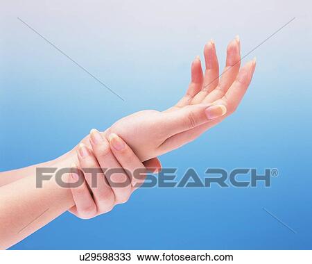 Stock Image - Woman putting her wrist on the other hand. Fotosearch