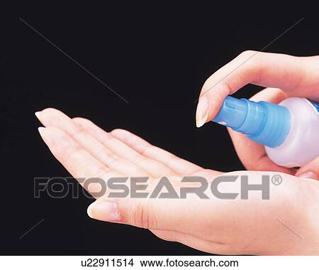Picture - Woman spraying on her palm. Fotosearch