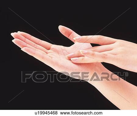 Woman touching her palm with long fingers View Large Photo Image Stock Photo - Woman touching her palm with long fingers. Fotosearch