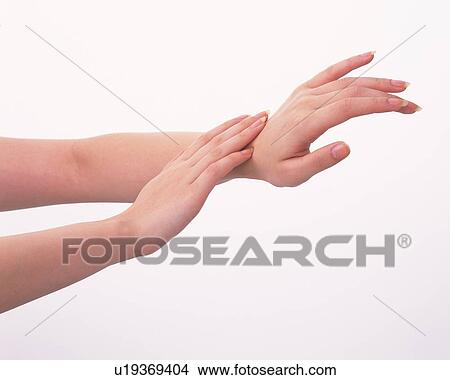 Picture - Woman touching her wrist. Fotosearch