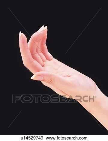 Stock Photo - Woman's hand, black background. Fotosearch