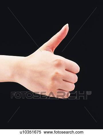 Stock Photography - Woman's hand giving thumbs up sign. Fotosearch