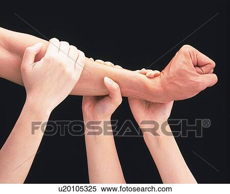 Stock Photography - Women clasping man's arm with fist. Fotosearch