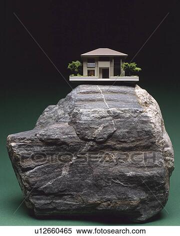 Stock Photography - A model of house on the rock. Fotosearch