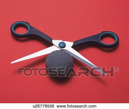 Stock Photograph - A pair of scissors and round stone. Fotosearch