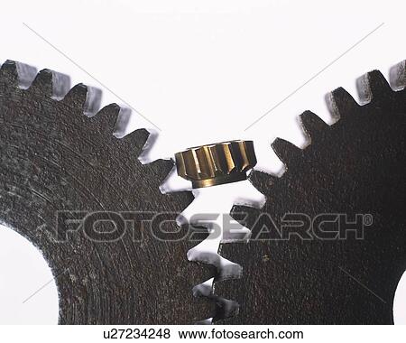 Stock Photo - A small wheel between two toothed gearwheels. Fotosearch