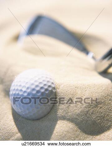 Picture - Golf club and ball on sand, close up. Fotosearch