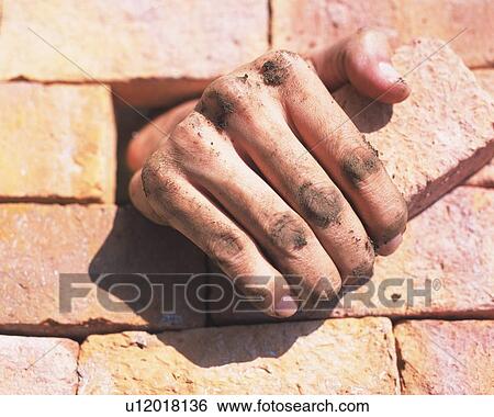 Stock Photograph - Human hand getting out of brick wall. Fotosearch