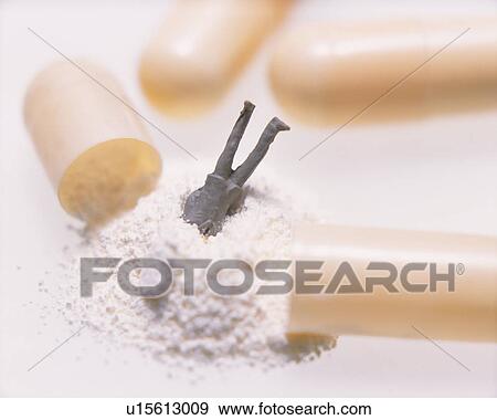 Stock Photo - Male figurine buried head in powdered medicine of capsule. Fotosearch