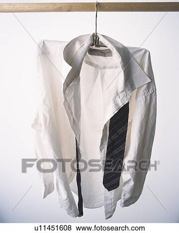 Shirt and tie hung at white wall View Large Photo Image Stock Photo - Shirt and tie hung at white wall. Fotosearch