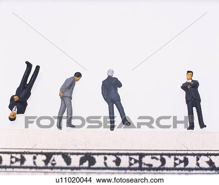 Picture - Toy figurines of men and part of bill. Fotosearch
