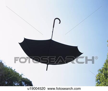 Stock Image - Umbrella flying in the air. Fotosearch