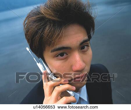 Closed Up Image of a Businessman Talking on his Cell Phone at the Beach, Looking at Camera, High Angle View View Large Photo Image Stock Image - Closed Up Image of a Businessman Talking on his Cell Phone at the Beach, Looking at Camera, High Angle View. Fotosearch