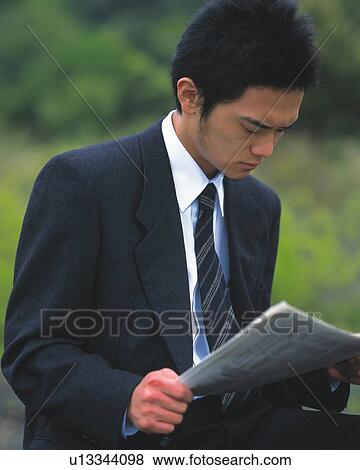 Closed Up Image of a Businessman Reading a Newspaper Outdoors With a Serious Look on his Face, Side View, Differential Focus View Large Photo Image Stock Photo - Closed Up Image of a Businessman Reading a Newspaper Outdoors With a Serious Look on his Face, Side View, Differential Focus. Fotosearch