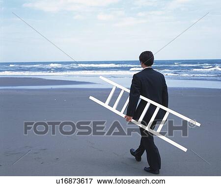 Image of a Businessman Carrying a Ladder and Walking Towards the Ocean, Rear View View Large Photo Image Stock Photo - Image of a Businessman Carrying a Ladder and Walking Towards the Ocean, Rear View. Fotosearch
