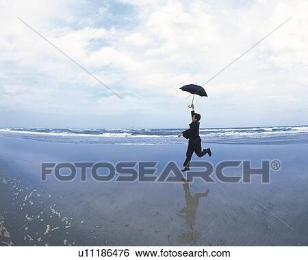 Image of a Businessman Jumping at the Beach With an Umbrella in his Hand, Side View View Large Photo Image Stock Photograph - Image of a Businessman Jumping at the Beach With an Umbrella in his Hand, Side View. Fotosearch