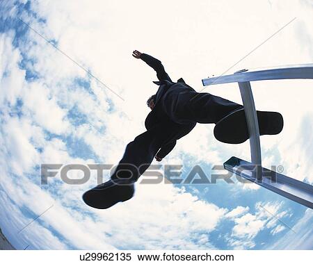 Stock Photography - Image of a Businessman Jumping Off From a Ladder Under a Blue Sky, Low Angle View, Fish Eye. Fotosearch