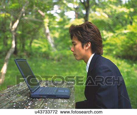 Image of a Businessman Looking at his Laptop Screen in the Forest, Side View, Differential Focus View Large Photo Image Stock Image - Image of a Businessman Looking at his Laptop Screen in the Forest, Side View, Differential Focus. Fotosearch