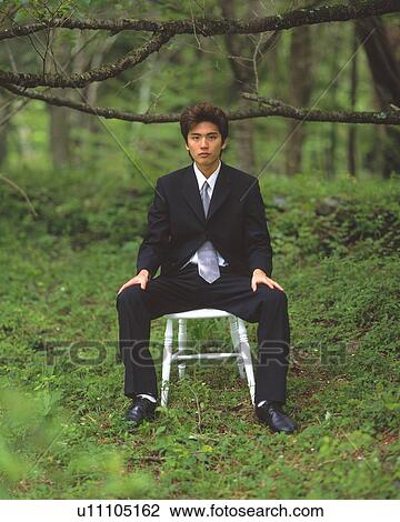 Image of a Businessman Sitting on a Chair in the Forest, Looking at Camera, Front View View Large Photo Image Stock Image - Image of a Businessman Sitting on a Chair in the Forest, Looking at Camera, Front View. Fotosearch