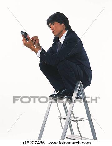 Image of a Businessman Sitting on a Stepladder, Using a Calculator, Side View View Large Photo Image Stock Photograph - Image of a Businessman Sitting on a Stepladder, Using a Calculator, Side View. Fotosearch