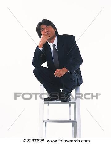 Image of a Businessman Sitting on a Stepladder, Thinking About Something, Looking Up, Low Angle View View Large Photo Image Stock Photography - Image of a Businessman Sitting on a Stepladder, Thinking About Something, Looking Up, Low Angle View. Fotosearch